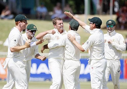 Peter Siddle is congratulated by his team-mates for taking a wicket