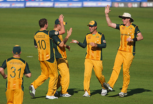 The Australians celebrate the fall of another New Zealand wicket