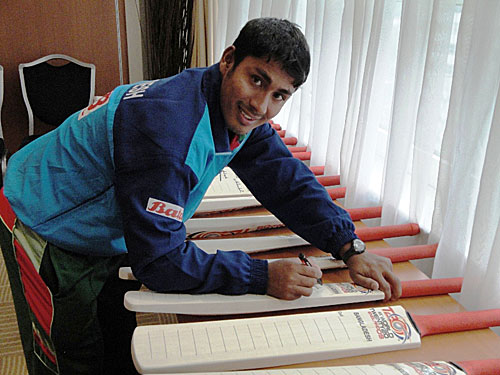 Mohammad Ashraful signs bats at the team hotel 