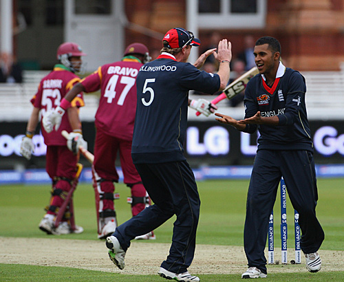 Paul Collingwood gives Adil Rashid five after the young legspinner finished with figures of 1 for 20 from his four overs