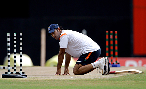 MS Dhoni inspects the pitch at the Beausejour Stadium 