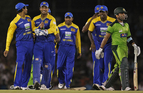 Sri Lanka's fielders celebrate the dismissal of Umar Akmal