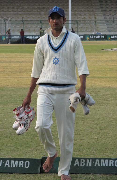 Asad Ali walks off the field after taking three wickets