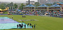 Groundsmen at Centurion mop up the soggy outfield